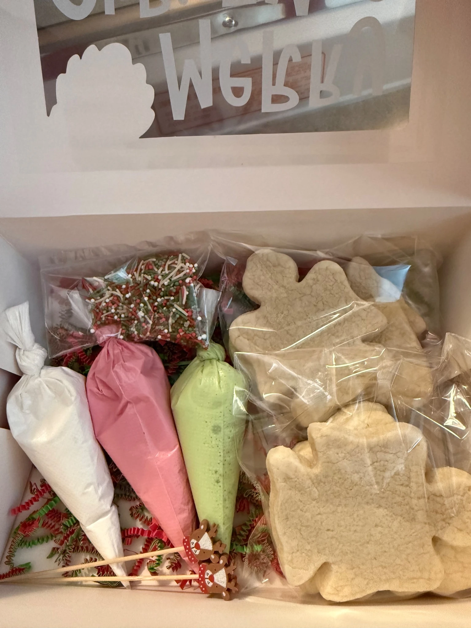 Open cookie decorating kit with cookies icing and sprinkles